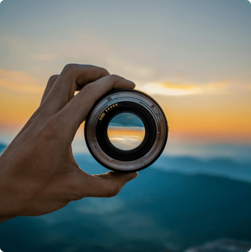 image of a hand holding a lens